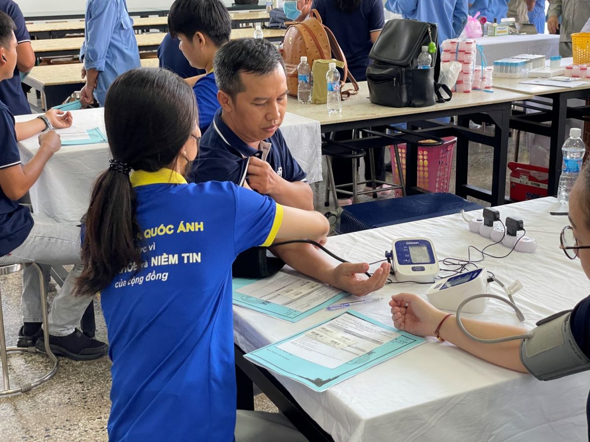 Medical staff checking the health of a Khang Viet employee